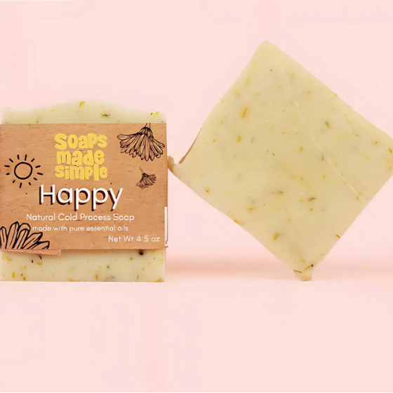 Bar of soap with a 'Happy' label and packaging on a pink background