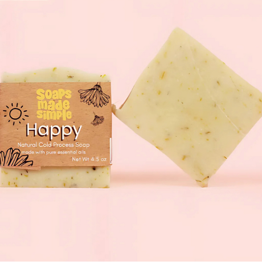 Bar of soap with a 'Happy' label and packaging on a pink background