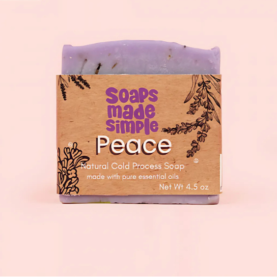Soap bar with 'Soaps Made Simple' packaging on a pink background