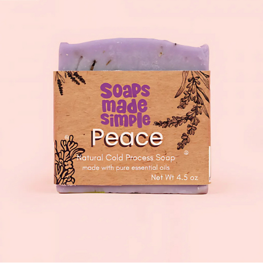 Soap bar with 'Soaps Made Simple' packaging on a pink background